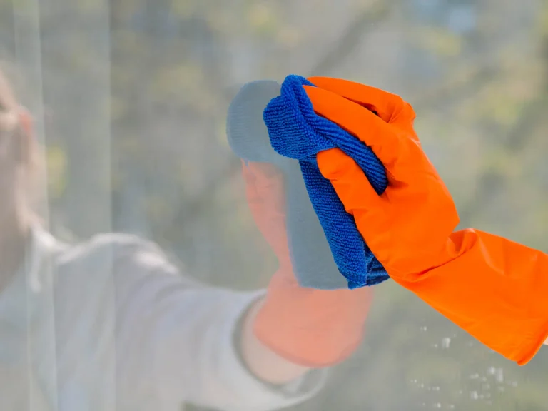 close-up-cleaning-window-with-cloth